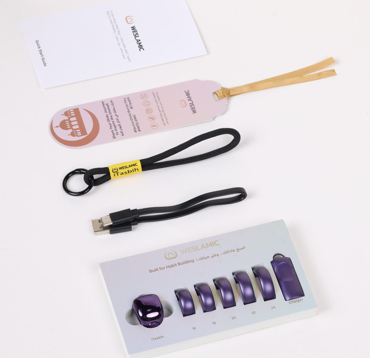 A set of Islamic wallet accessories from the brand WELAMIC, including a black lanyard with a USB connector, a black lanyard with a key ring, a white card, a light pink branded tag with wooden loops, and a white display card showing purple magnetic coin pouches.